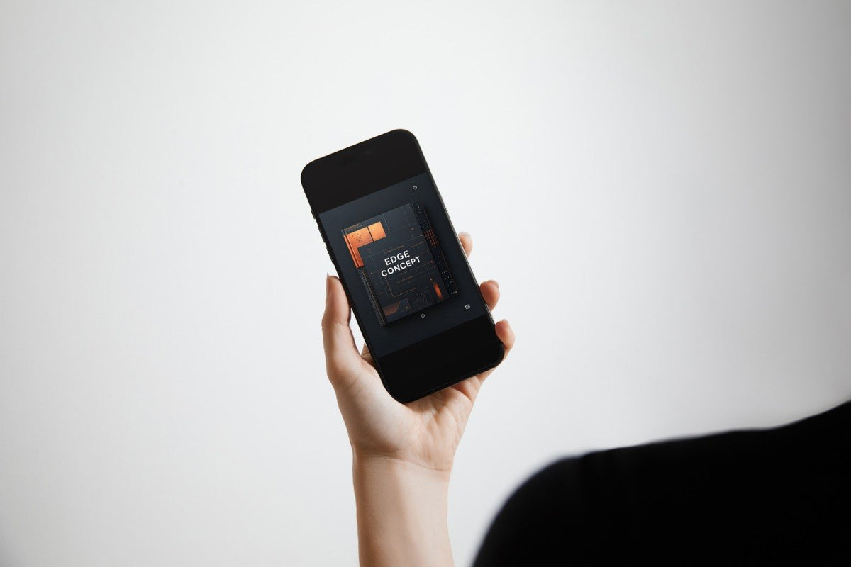 A hand holding a black smartphone against a light gray background, displaying a dark interface with orange accents on the screen.